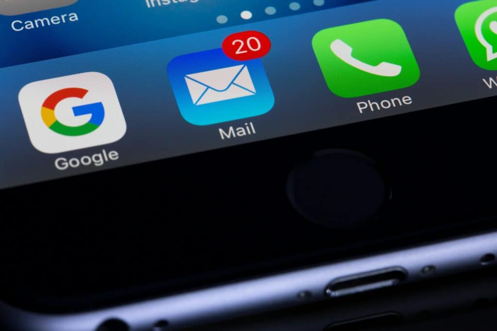 Close-up of a smartphone screen showing a mail app with 20 unread messages, next to Google and Phone apps. | Tsunami Reach
