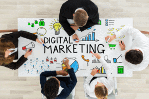Six people gather around a table with “Digital Marketing” and colorful business icons drawn on it. | Tsunami Reach