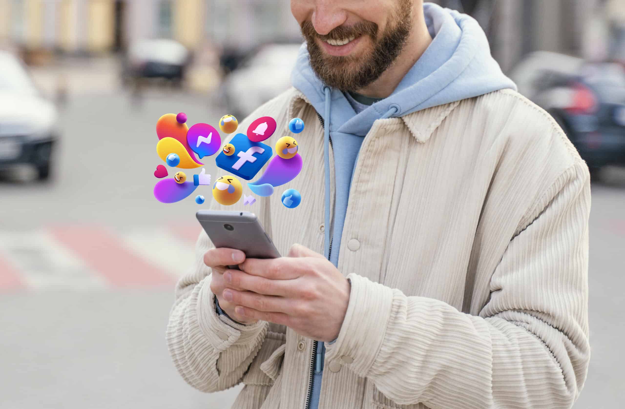 A smiling man uses his smartphone with colorful social media marketing icons floating above the screen. | Tsunami Reach