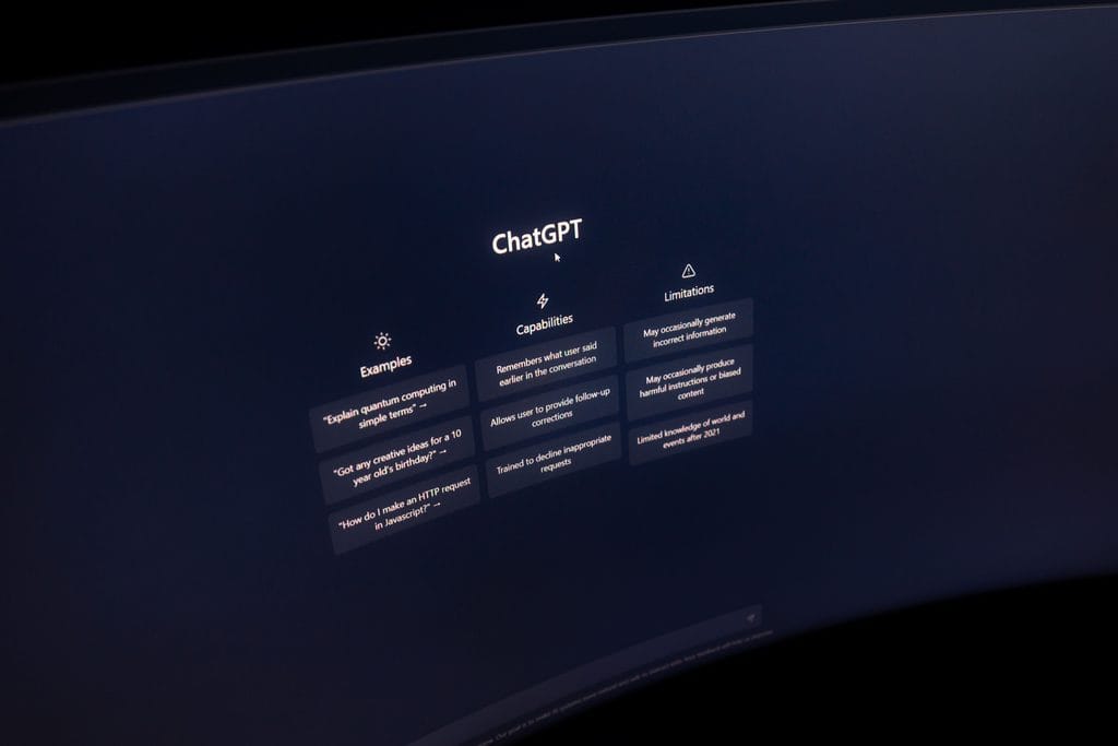 A dark screen displays ChatGPT’s interface with sections for examples, capabilities, and limitations. | Tsunami Reach